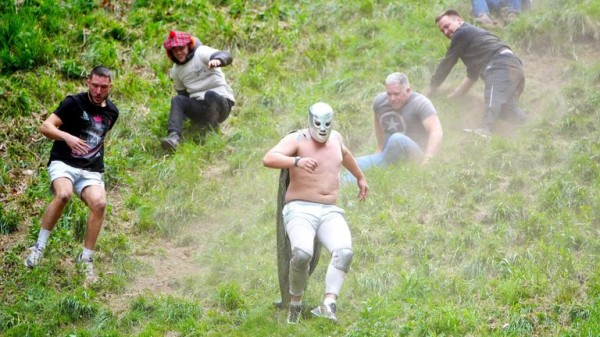 Cheese-loving daredevils hurl themselves down Cooper's Hill in Gloucestershire for famous race Cheese-loving daredevils hurl themselves down Cooper's Hill in Gloucestershire for famous race
