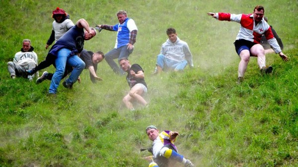 Cheese-loving daredevils hurl themselves down Cooper's Hill in Gloucestershire for famous race Cheese-loving daredevils hurl themselves down Cooper's Hill in Gloucestershire for famous race