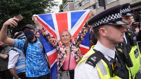 Rival groups face off outside migrant hotel - as asylum seekers 'blow kisses' at protesters Rival groups face off outside migrant hotel - as asylum seekers 'blow kisses' at protesters
