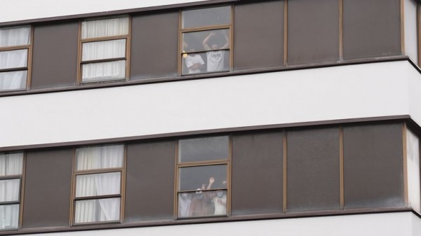 Rival groups face off outside migrant hotel - as asylum seekers 'blow kisses' at protesters Rival groups face off outside migrant hotel - as asylum seekers 'blow kisses' at protesters